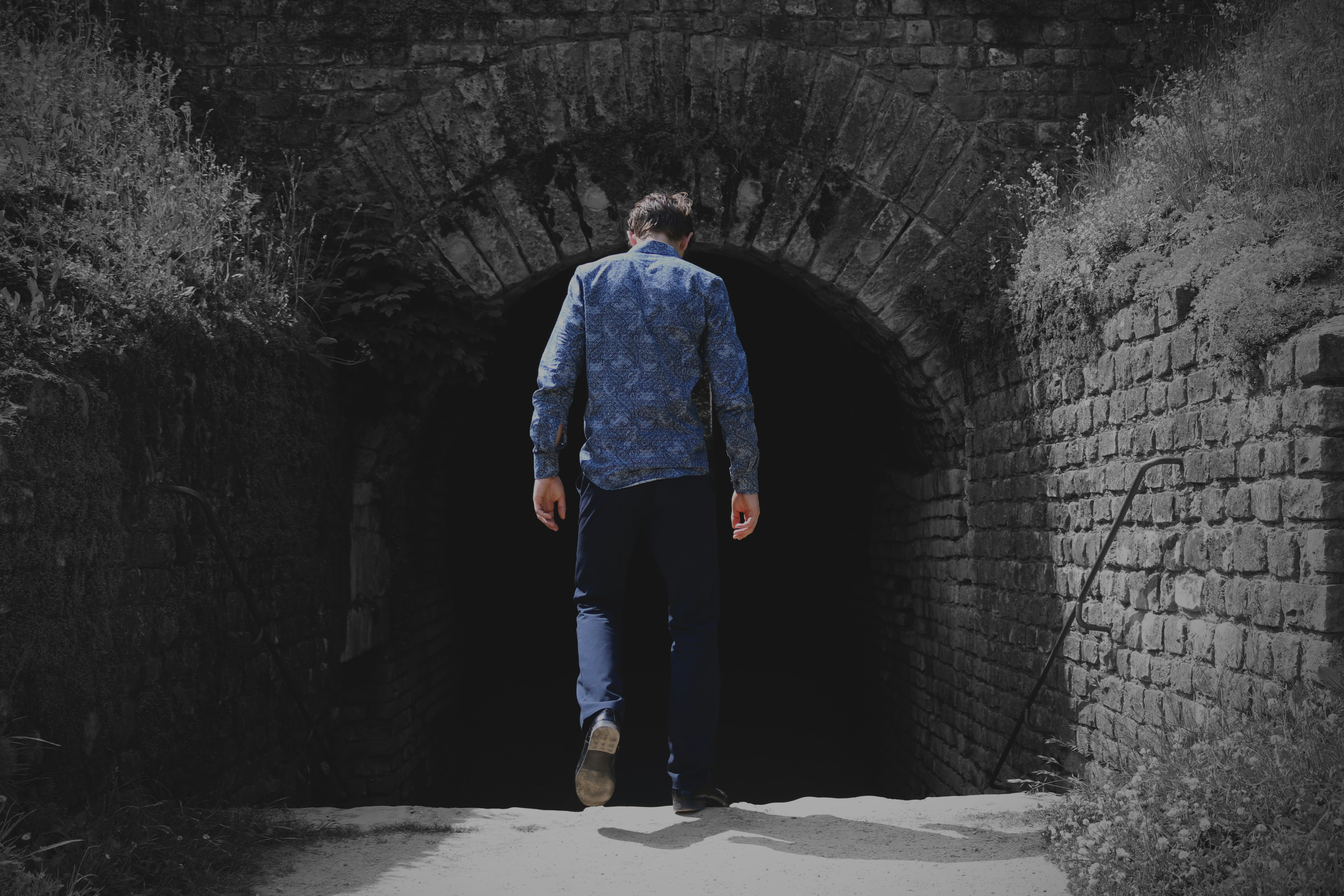 man walking to tunnel